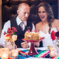 Red flower centerpieces and cake stand