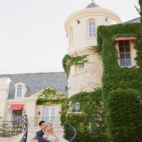 Bride and groom pose on staircase of Justin Vineyards and Winery